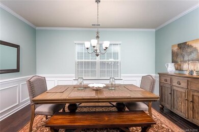 Formal dining room with hardwood floors, wainscot 