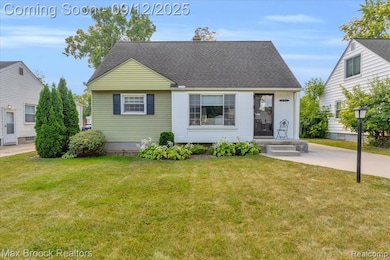View of front of home with a front lawn, roof with shingles, and a chimney