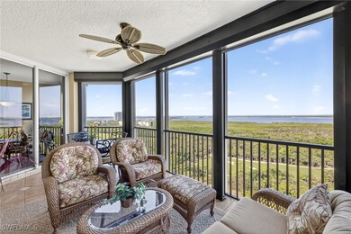 Balconyfeaturing a textured ceiling, a water view, floor to ceiling windows, and tile patterned flooring