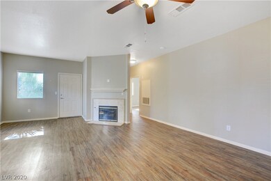 LIVING ROOM WITH CEILING FAN AND FIREPLACE