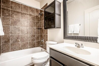 The first full bath with tile surround and Framed 
