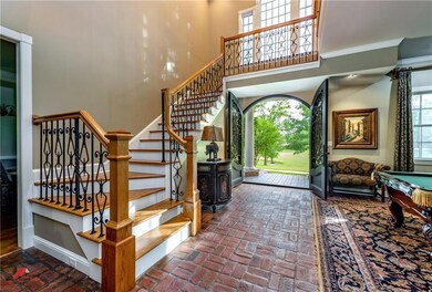 Spacious foyer with brick floors and stairs to the