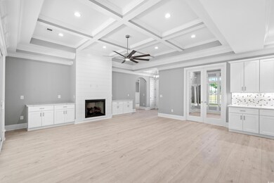 Unfurnished living room with a fireplace, coffered