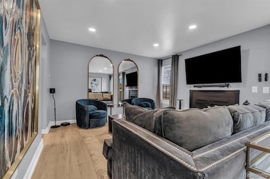 Living room featuring light wood finished floors and recessed lighting