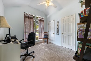 Carpeted office space with lofted ceiling and cei