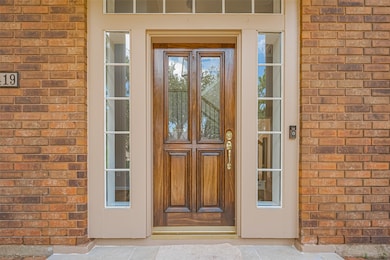 Beautiful entry framed by spacious and tall porch