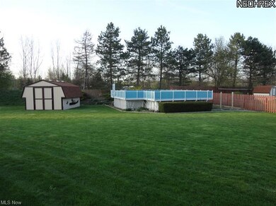 Long shot view of back yard, pool & shed