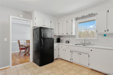 Kitchen with white cabinets, light  flooring, and