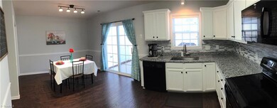 The large updated kitchen looks out onto the fenced patio and dinning area. Say hello to the updated granite counter tops. This kitchen has lots of storage and counter space for the chief in the family.