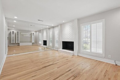 Unfurnished living room featuring a brick fireplac