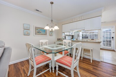 Dining space with wood finished floors, visible ve