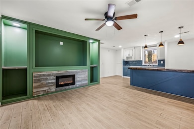 The living room is a beautiful open space featuring a stunning wall with built in storage