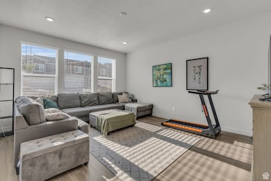 Living area with wood finished floors and recessed lighting