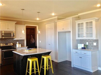 Custom lighting, granite, and tile backsplash.