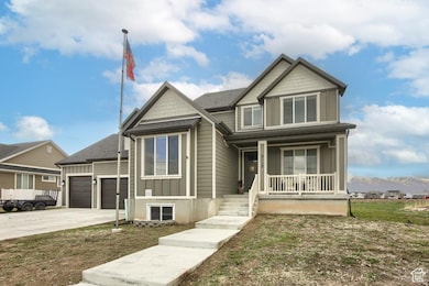 View of front of house with an attached garage, covered porch, and concrete driveway