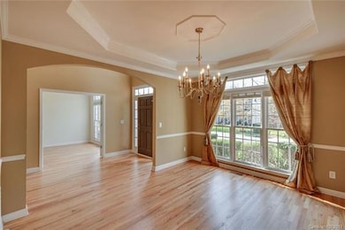 Dining Room offers Trey Ceiling, Wood Floors, Impr
