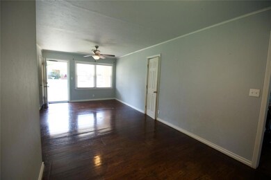 Spare room with wood-type flooring and ceiling fan