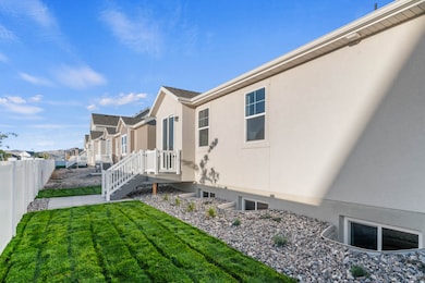 View of side of property with a residential view, stucco siding, and a deck