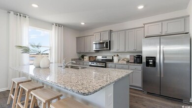 Kitchen with a kitchen island with sink, a kitchen
