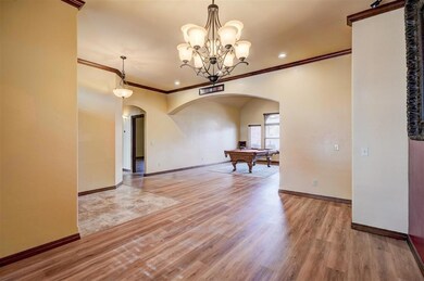 Dining area and living room showing arched doorway
