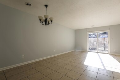 Empty room featuring an inviting chandelier and li