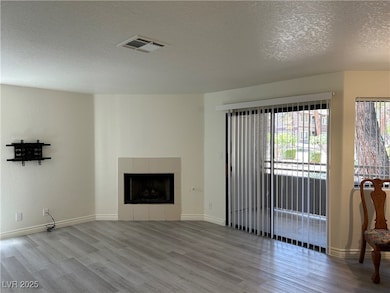 Unfurnished living room featuring wood finished fl
