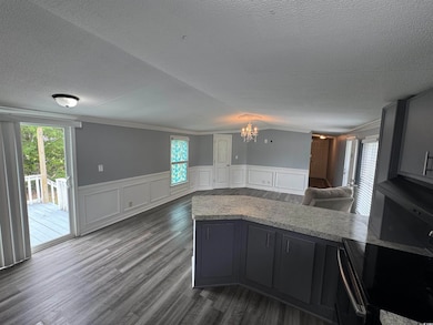 Kitchen with open floor plan, a textured ceiling, 