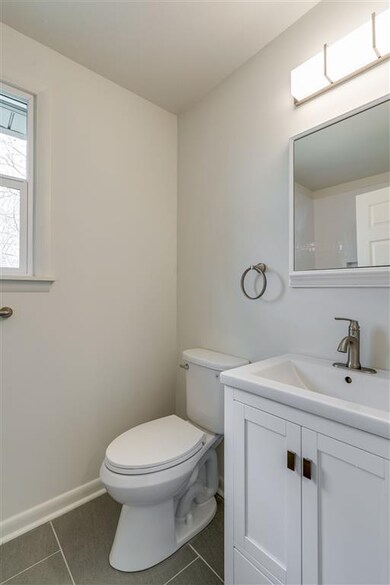 New elongated toilet and vanity.  Mirror has storage.