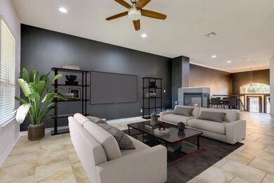 Living room with ceiling fan with notable chandel