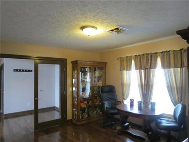 Large formal dining room with glass french doors and hardwood floors welcomes your guest as they enter the front door. This is the perfect room for Christmas dinner with the family.