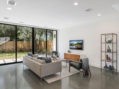 Living area featuring finished concrete floors, v