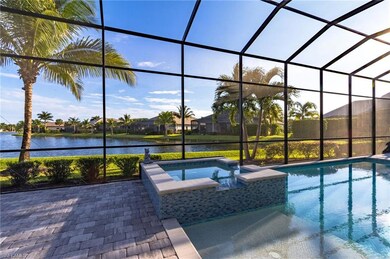 View of swimming pool with glass enclosure, a water view, an in ground hot tub, and a patio