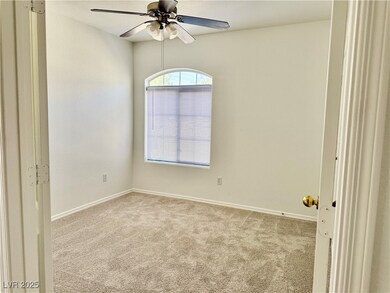 Empty room featuring carpet and ceiling fan