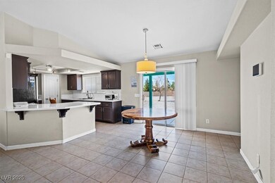 Kitchen with visible vents, a breakfast bar, dark