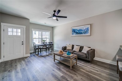 Living room with wood finished floors, baseboards,