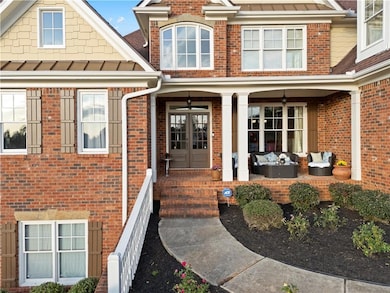 Entrance to property featuring brick siding, a sta