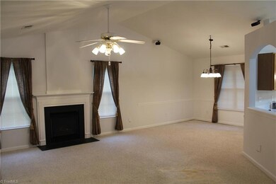 Open floor plan with vaulted ceiling
