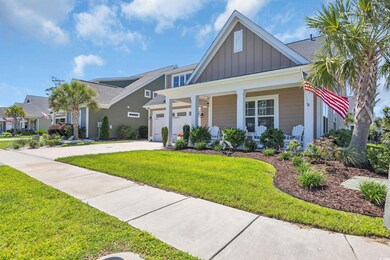 View of front of home with a covered front porch with seating area, custom concrete driveway, a landscaped front yard, and a 2 car garage