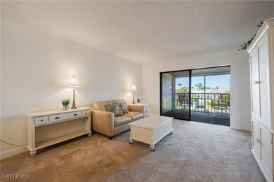 Living room with carpet flooring and a textured ce