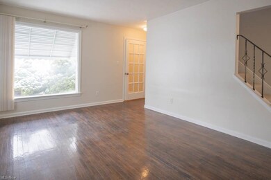 The living room boasts gleaming hardwood floors an