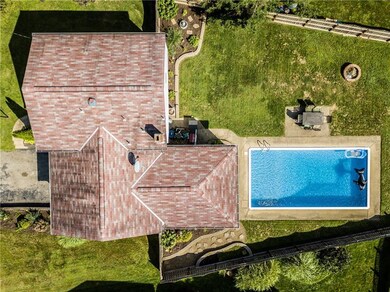 Aerial view shows a spacious home with level lot a