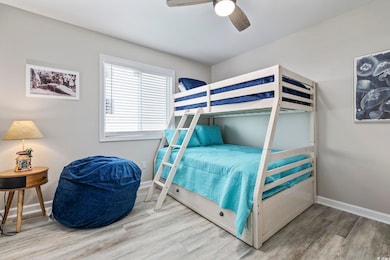 Bedroom with light wood-type flooring and a ceiling fan