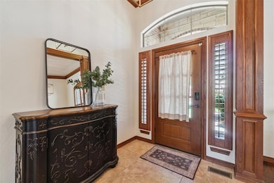 Foyer entrance featuring baseboards and light tile patterned floors