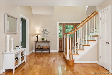 Stairway with light hardwood / wood-style flooring