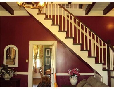 Stairs. Parlor from entry with indoor staircase