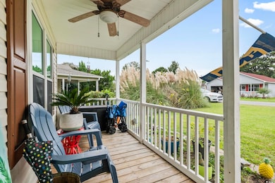 Wooden terrace with a lawn, ceiling fan, and cover