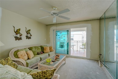 Living area featuring a textured ceiling and a ceiling fan
