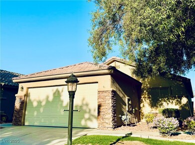 View of front facade with a garage, stucco siding,