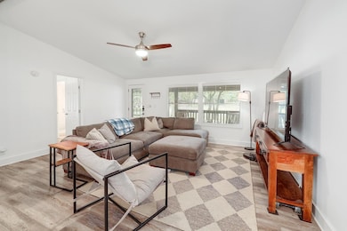 Living room with lofted ceiling, light wood-style