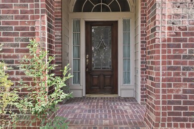 Welcomed by a brick porch entryway.